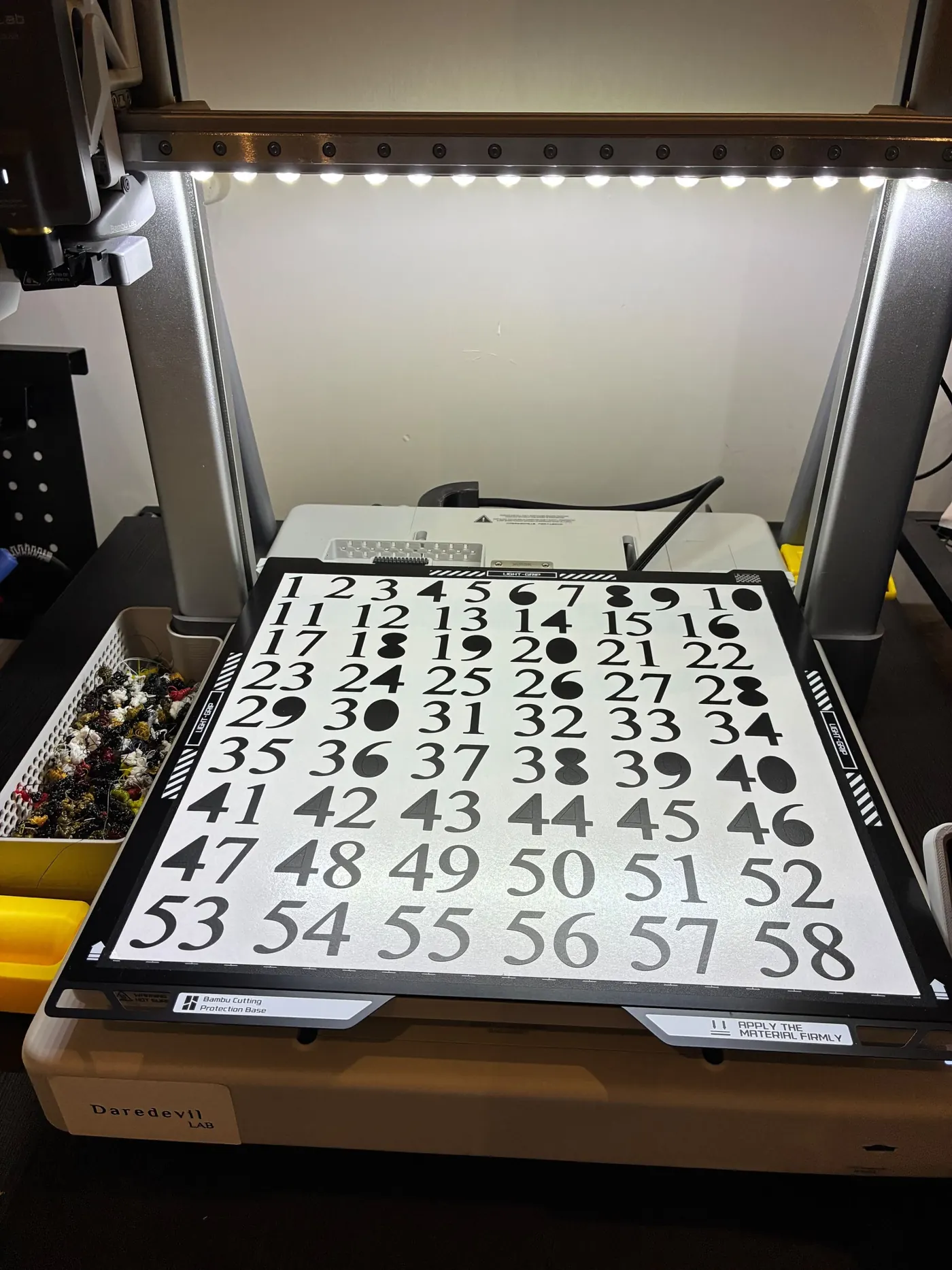 A sheet of cut numbers on the Daredevil Lab cutting machine in the workshop