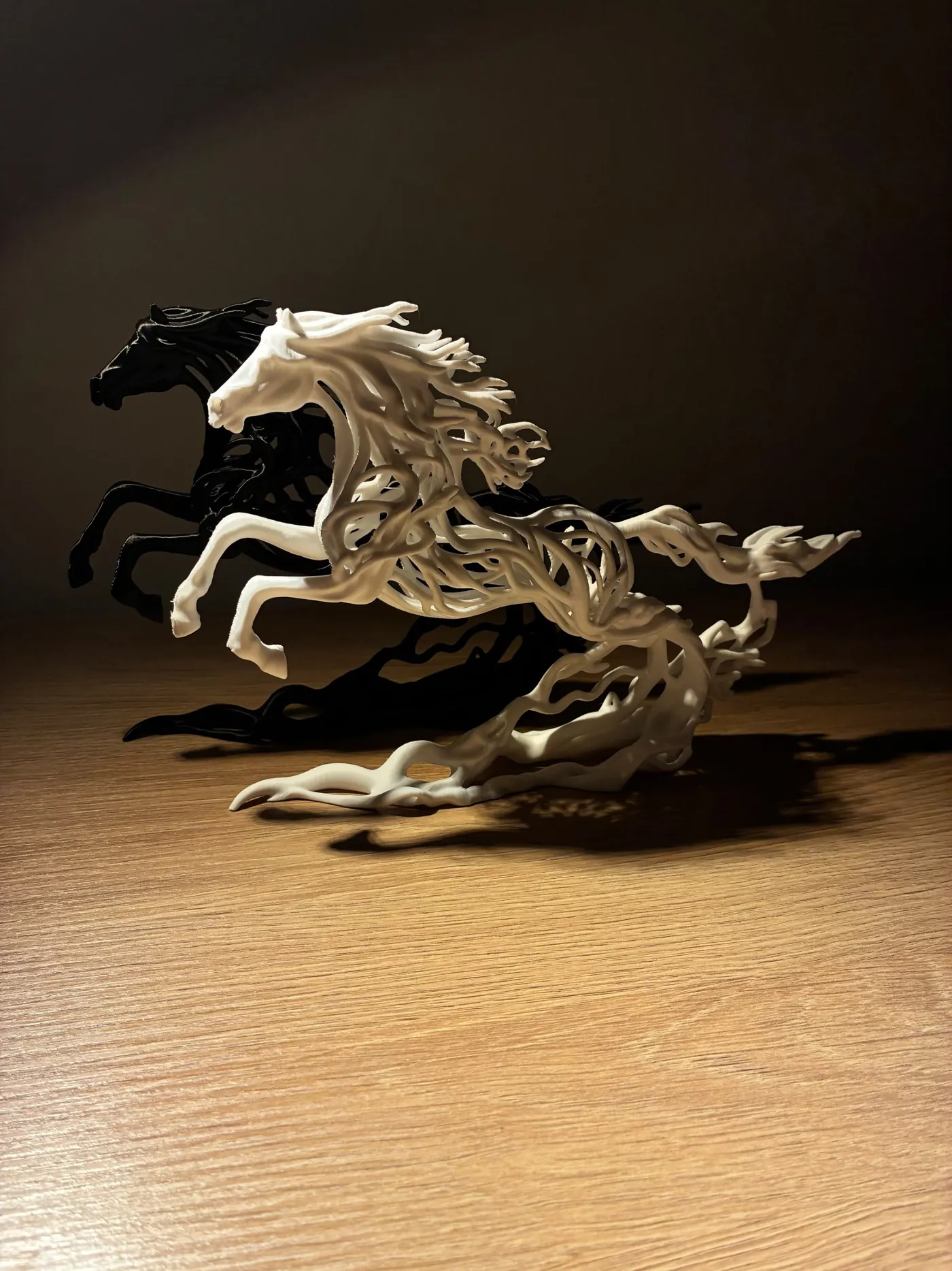 The Running Horses sculpture made in black and in white, side by side