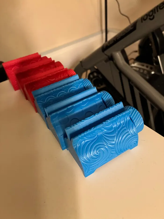 Row of red and blue 3D printed stands with different surface textures